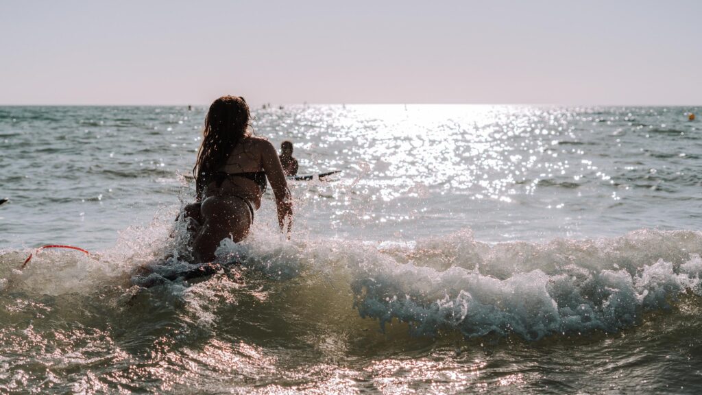 a surfer jumping back to water