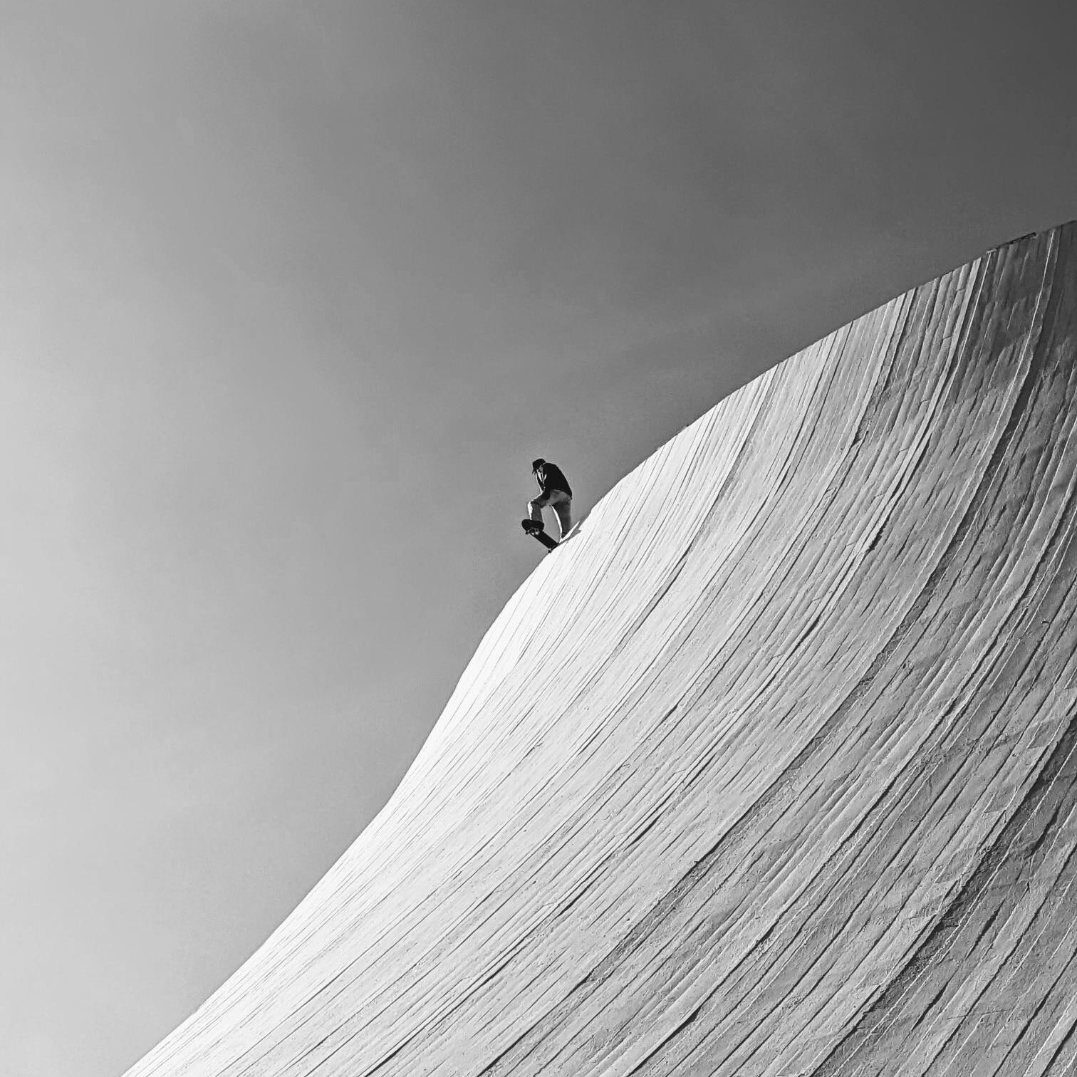 a snowboarder getting ready to go doing a snowy hill