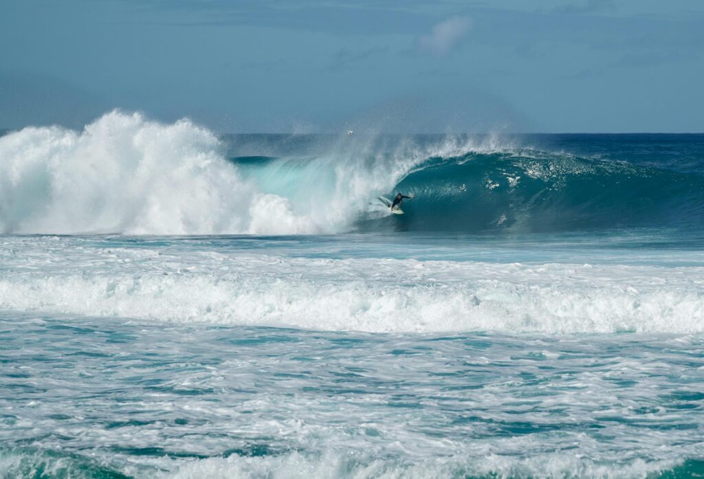 a beach in hawai with a surfer