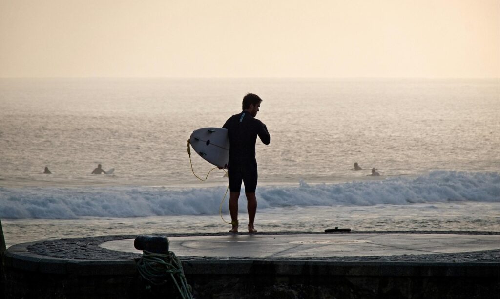 a surfer holding his surfboard