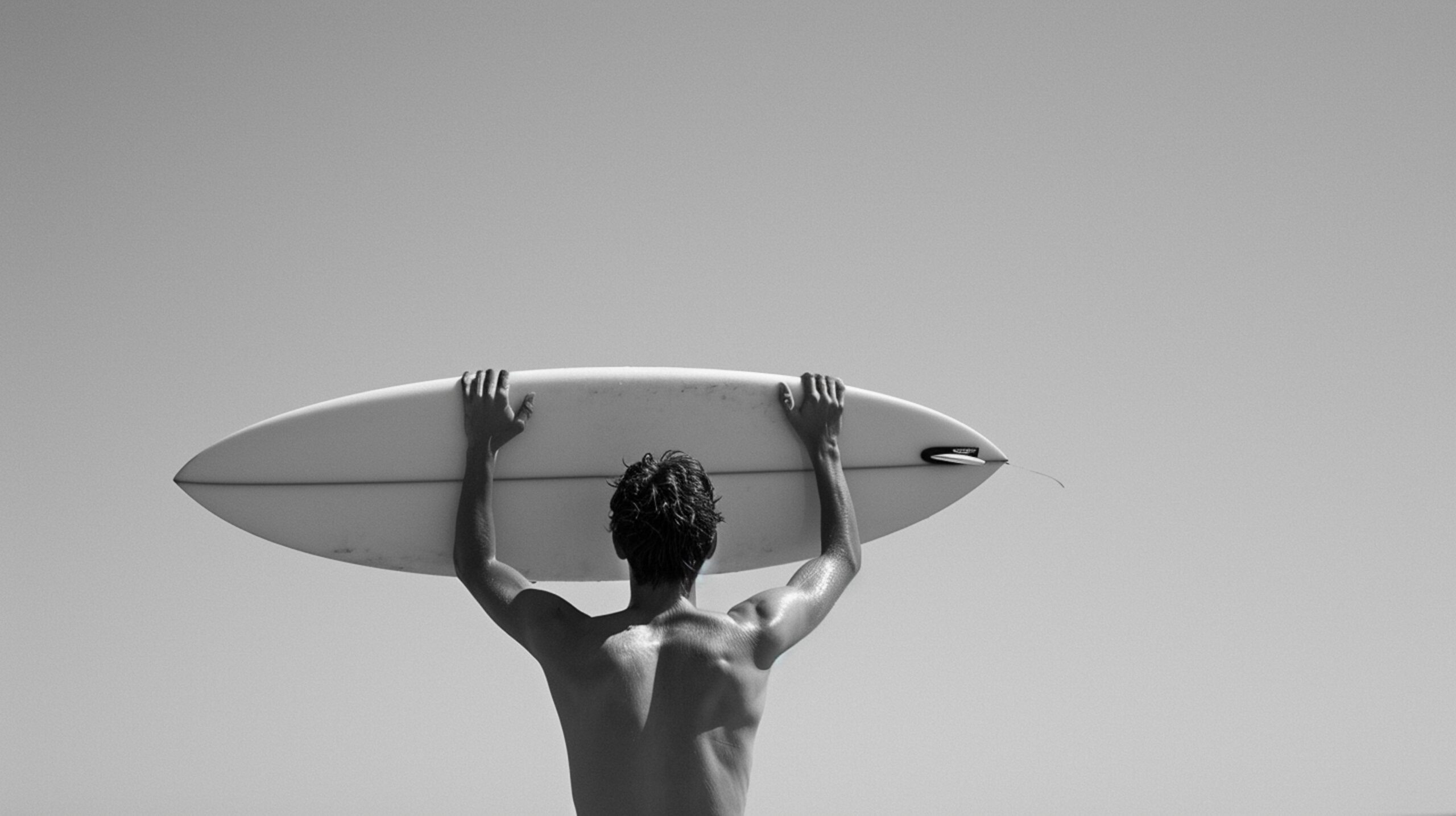 a man holding a surf on his hands