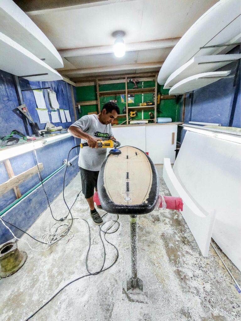 a guy repairing a surboard