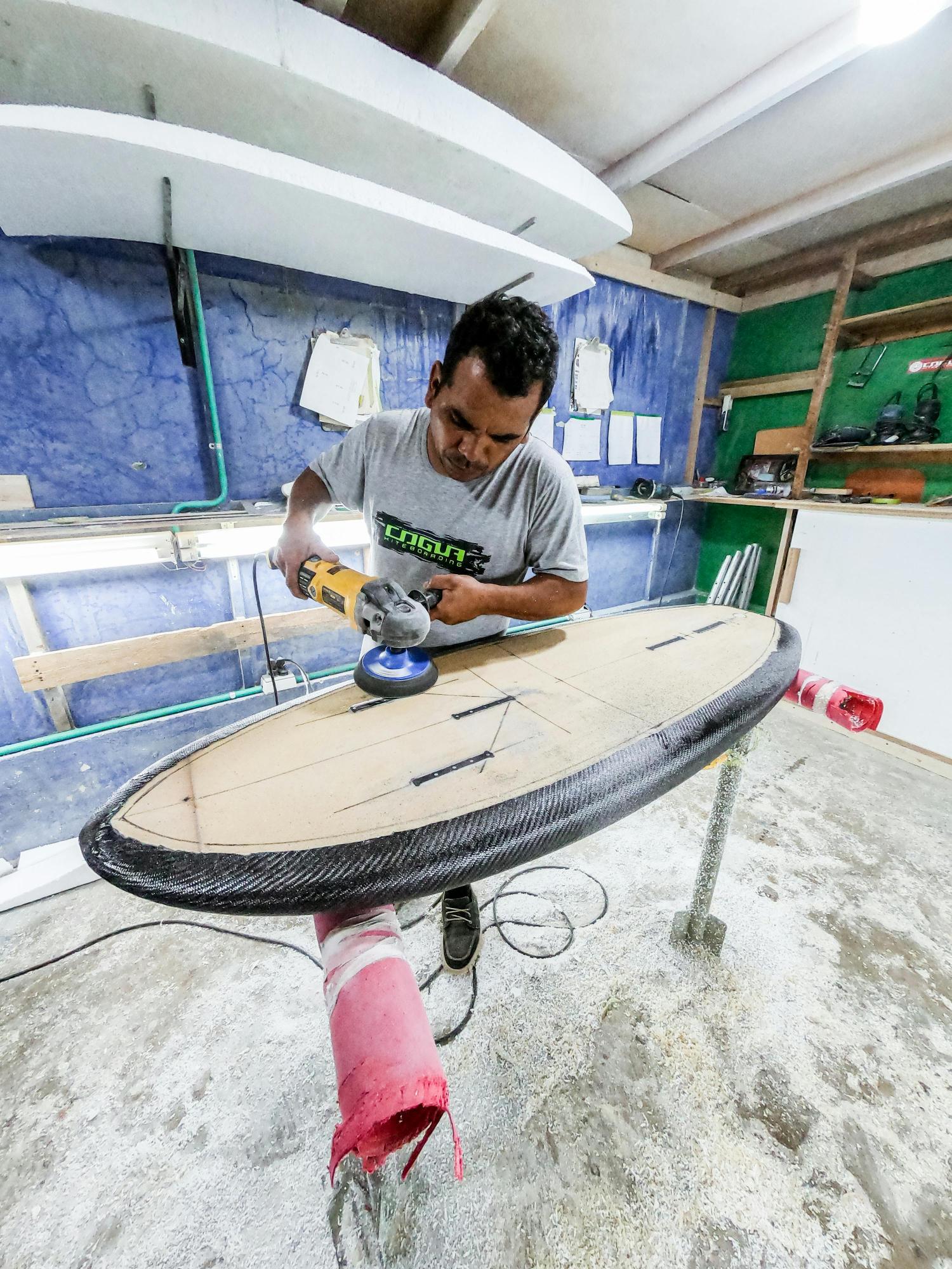 a person repairing a surfboard