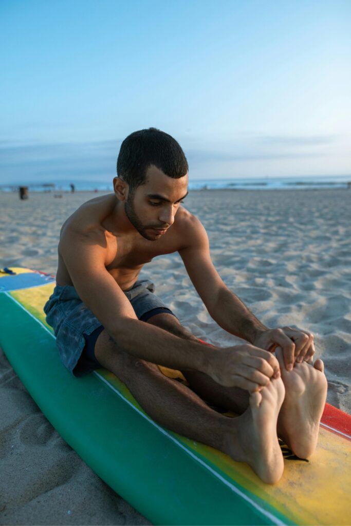 a surfer stretching before doing a session 