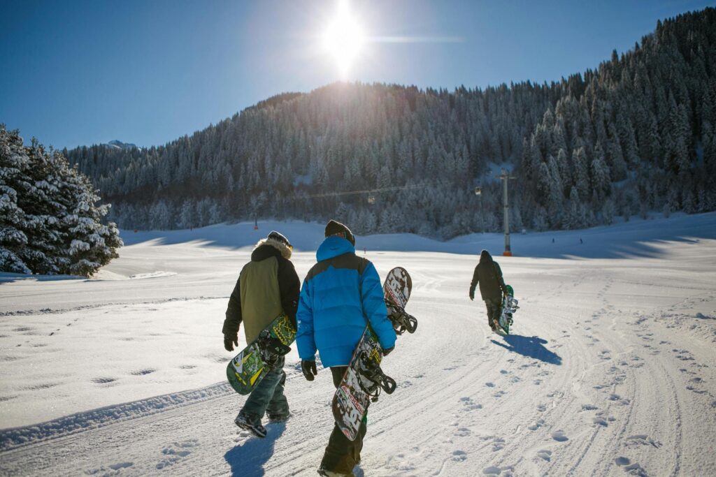 a groupe of snowboarders climbing a snow mountain