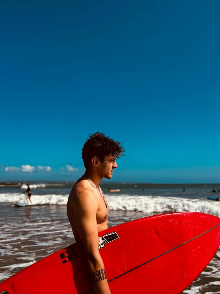 a surfer holding his surfboard