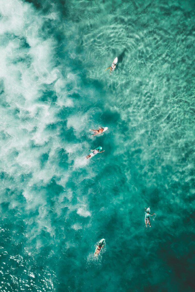 a couple of people learning how to surf