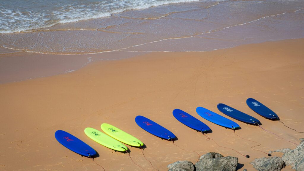 a couple of surfboards on the sandy beach