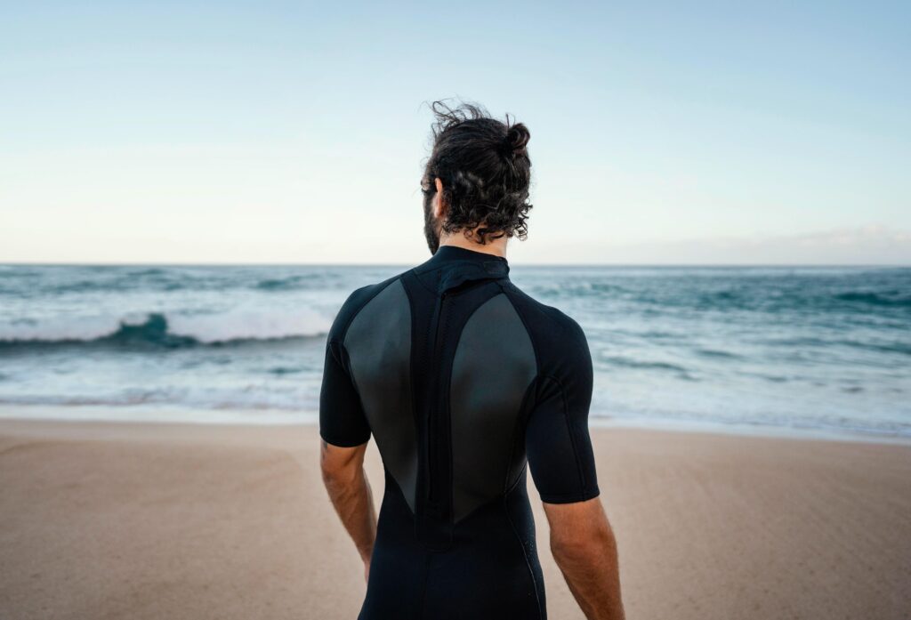 an ocean with a guy wearing a back zipper suit