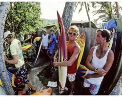 a group of surfer getting ready to ride the waves