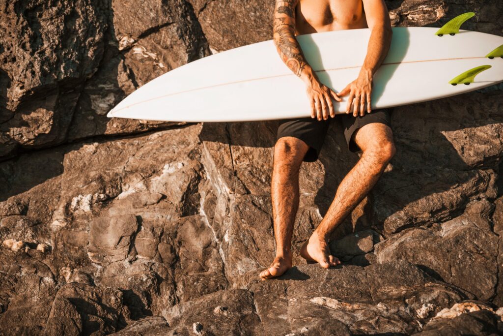 a surfer holding his surfboard